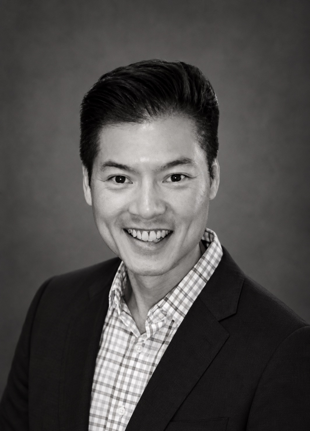 Black-and-white portrait of John Huang